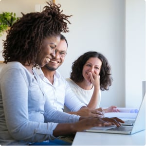 Women and man laughing laptop